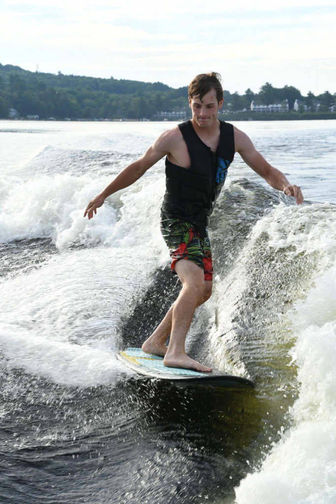 Zeke, Tocci, one of the instructors rips up a wave on a wake surf board.