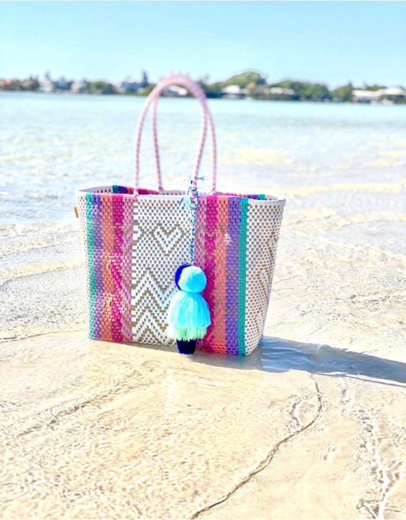 A Squeeze De Citron bag stands aesthetically on the beach. They are waterproof, durable, and fun!